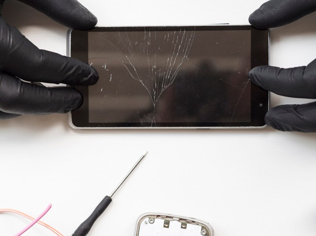 Flat lay man holding broken phone 23 2148254063