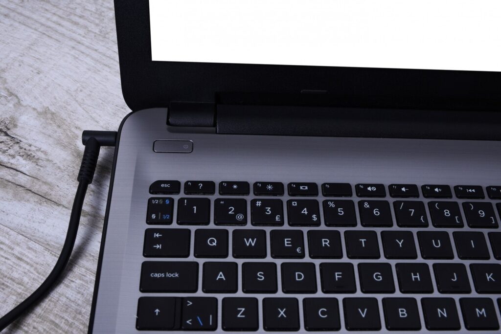 Laptop computer is charging from 220 volt outlet desk near wall energy accumulation 150455 1279