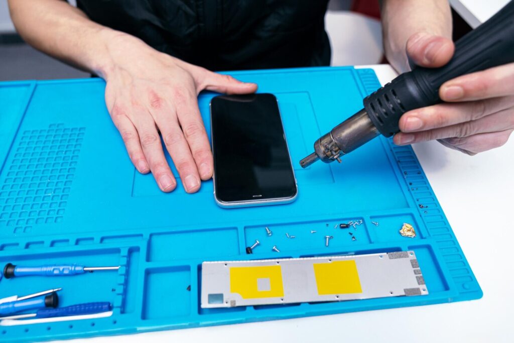Closeup heat gun disassembling phone 198115 2771 Closeup heat gun disassembling phone 198115 2771