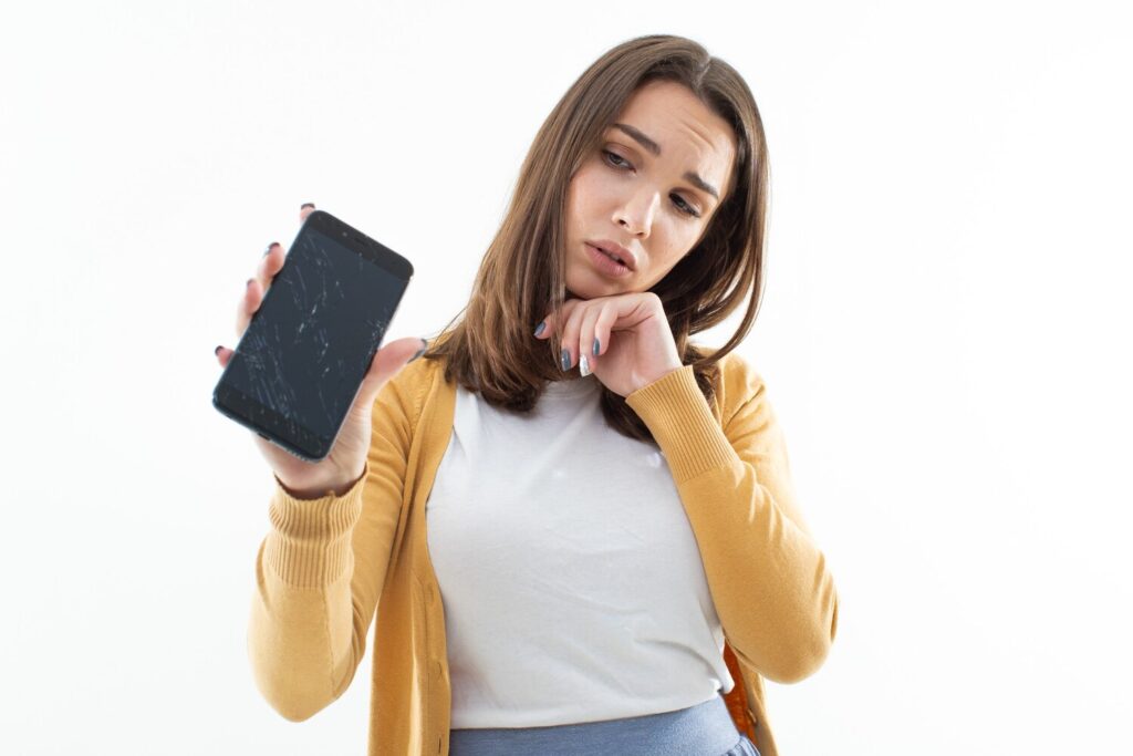 Beautiful young woman with broken phone 307890 1134 Beautiful young woman with broken phone 307890 1134