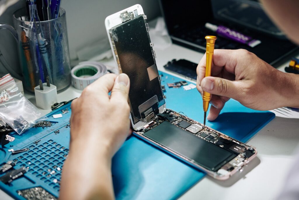 Smartphone repairman removing screws 274689 4838