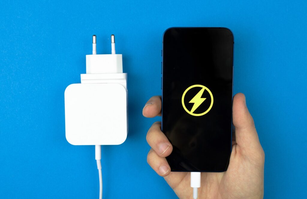 Charging mobile phone with charger adapter hand with smartphone with energy icon power charger bright background top view flat lay photo 526934 3072 Charging mobile phone with charger adapter hand with smartphone with energy icon power charger bright background top view flat lay photo 526934 3072