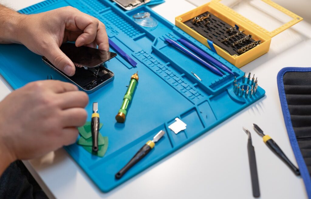 Technician fixing broken smartphone 102556 1478 Technician fixing broken smartphone 102556 1478